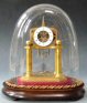 Miniature brass skeleton clock with glass dome, in the James Condliff style with a special escapement. Circa 1830-40.